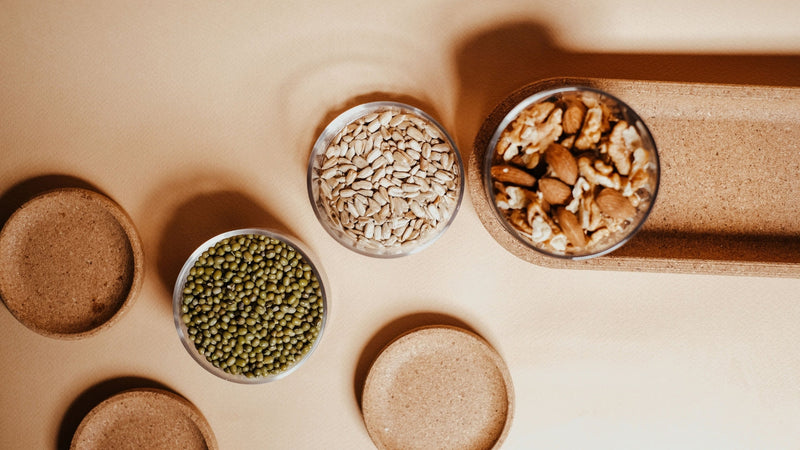 Brazil nuts, seeds and bowls of grains on a counter